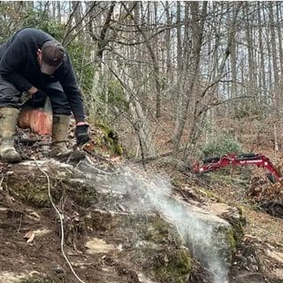 Repair work on a buried line on a hillside